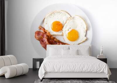 Fried eggs and bacon for breakfast isolated on white background. Top view Wall mural