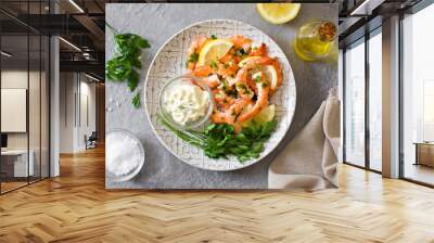 Grilled shrimps, parsley and lemon on gray stone. Top view Wall mural