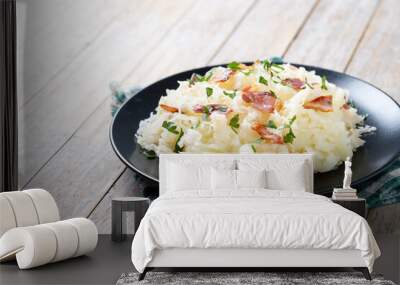 Slovak potato dumplings halusky with steamed sauerkraut and bacon on wooden table. Copy space Wall mural