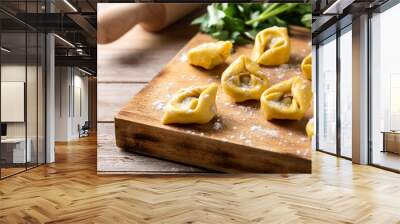 Uncooked pelmeni dumplings on rustic wooden table. typical russian food Wall mural