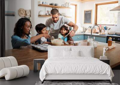 The whole family is getting involved. Cropped shot of a young couple baking at home with their two children. Wall mural