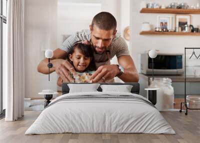 Baking brings out the artist in us all. Cropped shot of a young man baking at home with his young daughter. Wall mural