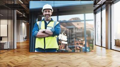 Engineer, portrait of man architect standing in front of construction site and arms crossed. Industrial or architecture, project or management and happy mature male worker with safety helmet Wall mural