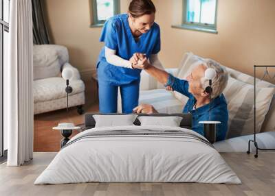 Her caring nature makes her the perfect caregiver. Shot of a caregiver assisting her senior patient at home. Wall mural