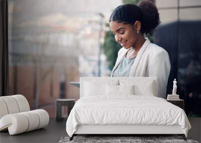 Modern business woman on a tablet during a work break alone outside. Smiling corporate worker looking at web and social media posts on a balcony. Female employee on a digital device with copyspace Wall mural