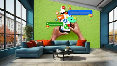 Phone, person hands and social media emojis for online network, contact or application feedback. Cellphone, closeup and user typing post, communication and like notification on green background wall Wall mural