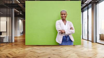 Portrait, fashion and black woman smile with arms crossed on green wall background mockup space. Positive designer, happy and confident African person in style, casual clothes and trendy in Nigeria Wall mural