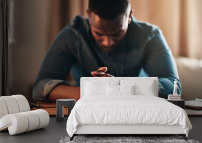 Quiet, calm and spiritual man praying while kneeling with his hands clasped alone at home. Prayerful, spiritual and religious, Christian male saying a daily prayer in the morning in a bedroom Wall mural