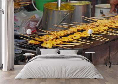 pork satay grill on hot stove,Pork satay is a street thai food ,light and delicious, suitable for snacks. Wall mural