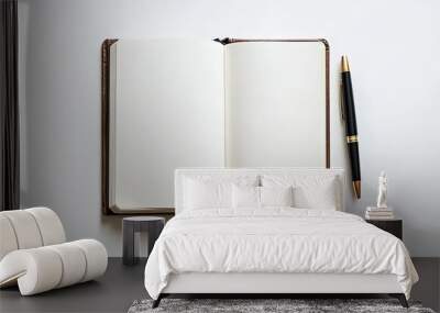 Clean white background featuring an open book with blank pages and a classic pen placed beside it Wall mural