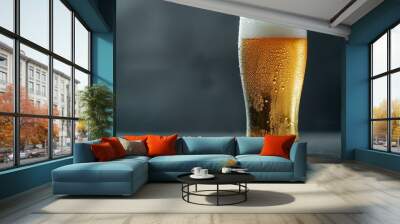 Clear glass of pale lager with condensation and a frothy top Wall mural