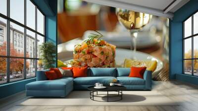 Detailed view of raw salmon tartare with zesty toast sauce, lemon, and a glass of white wine, showcased in a softly focused restaurant setting Wall mural