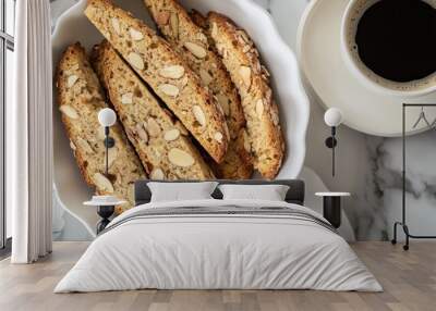 Fresh almond biscotti in a white dish, with coffee on the side Wall mural