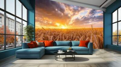 Golden wheat field under a dramatic sky filled with billowing clouds at sunset Wall mural