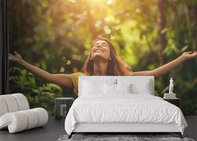 Overjoyed happy woman enjoying the green beautiful nature woods forest around her - concept of female people and healthy natural Wall mural