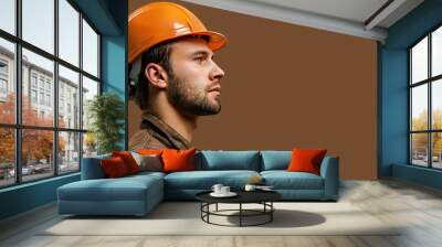 Profile of engineer in hard hat and badge on brown backdrop Wall mural