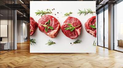 Selection of raw marbled beef steaks with fresh herbs, isolated on white Wall mural