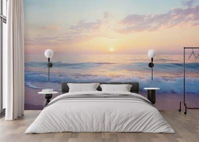 Serene beach at sunrise with gentle waves and a pastel sky Wall mural