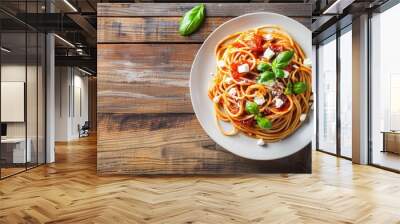 Spaghetti with tomato sauce, feta cheese and basil leaves on white plate on wooden background. Italian healthy food background. Wall mural