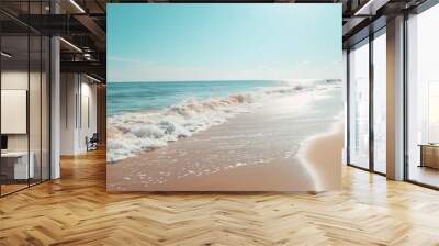 Sunny beach with gentle waves and clear sky, perfect for summer vacation ads Wall mural