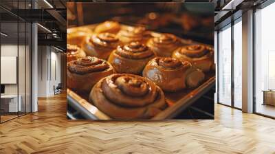 tray of golden brown cinnamon rolls fresh from the oven, their sweet aroma filling the kitchen with warmth and comfort. Wall mural