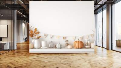 White shelf with autumn decor items like pumpkins and leaves, set against a white wall with a banner for seasonal messages and copy space Wall mural