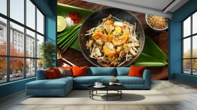 Thai traditional food: Still life of Pad Thai, stired noodles with shrimps, egg served with lime,vegetable. Pad Thai is popular on street food, Thailand, Clean food good taste concept. Wall mural