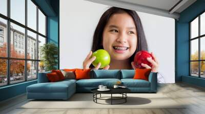 healthy asian woman hold red and green apples in her hand and smile happily Wall mural