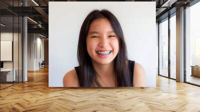 portrait of asian woman face with colorful braces and smile happily Wall mural