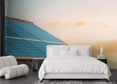 a solar panel on a roof, showcasing renewable energy technology against a beautiful sunset background. Wall mural