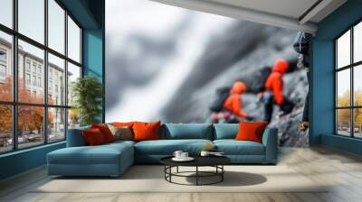 Adventurous climbers ascend a rugged mountain slope, showcasing determination and teamwork against a stunning backdrop of snow. Wall mural