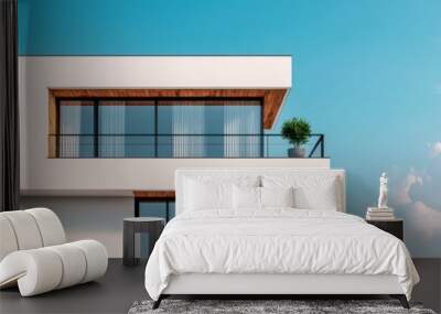 Modern architecture featuring a stylish house with large windows and greenery under a clear blue sky. Wall mural