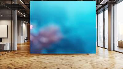 Vibrant coral thriving underwater, showcasing stunning colors against a tranquil blue background. A glimpse into marine beauty. Wall mural