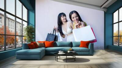 Woman enjoying shopping with shopping bags Consumerism, shopping, lifestyle concept Wall mural