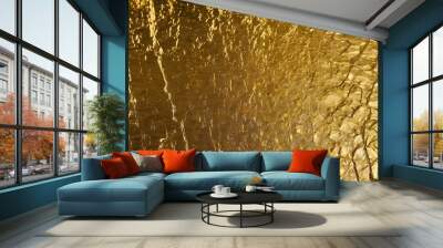 Gold texture. A brown surface with clear, detailed, raised patterns alternating with gold illustrations. Gold walls and backgrounds. Wall mural