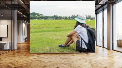 Young travel girl sitting at nature park, Hipster woman with bac Wall mural