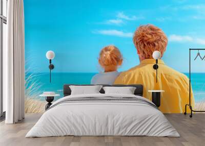 A father and daughter enjoy a serene moment at the beach on a clear sunny day Wall mural