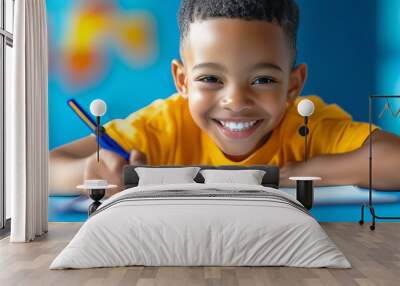 A joyful young boy engaging in creative drawing at a colorful art table in a bright room Wall mural