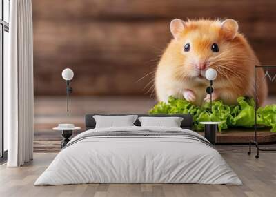 Cute hamster enjoying fresh lettuce on a wooden surface in a cozy indoor setting Wall mural