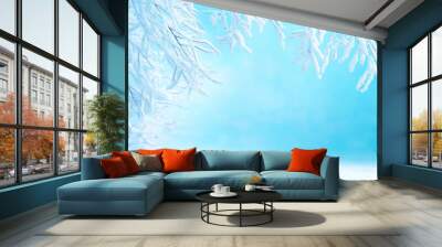 Winter wonderland with frosted trees and soft blue background during a serene snowy day Wall mural