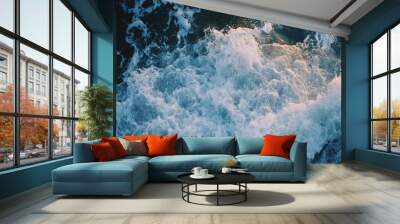 A stunning image capturing the dynamic and energetic motion of ocean waves as they crash and foam, showcasing the raw power and beauty of nature in a captivating way. Wall mural