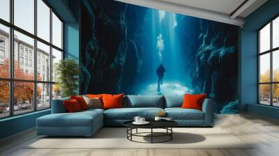 Scuba diver exploring underwater cave with sunlight coming in from the surface Wall mural