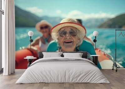 The image depicts a joyful senior woman in a hat and sunglasses, steering a boat with friends, enjoying a sunny day on the lake, surrounded by beautiful natural scenery. Wall mural