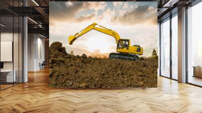 Crawler Excavators are bucket lift up in the construction site on the sunset sky backgrounds. Wall mural