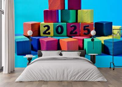 2025 written on colored wood blocks representing New Year 2025 Wall mural