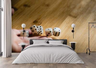 Dices bouncing on a wooden table. Single or group Wall mural