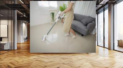 Attractive house wife Asian woman. beautiful successful woman cleaning living room . Wall mural