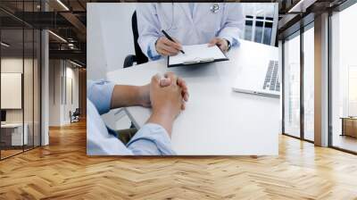 Professional medical doctor in white uniform gown coat interview consulting patient. Wall mural