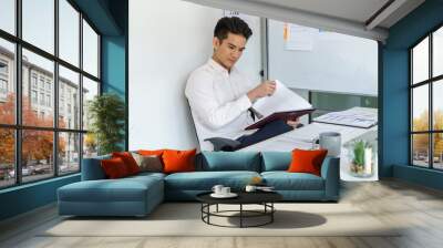 Young business man busy working at office. businessman doing financial paperwork business management concept Wall mural