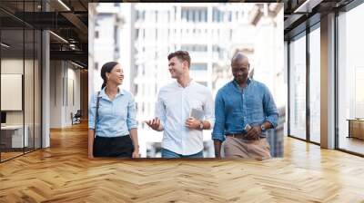 Business people, friends and city group walking, talking and chatting about work project while outside on an urban street. Diversity, happy and employees planning, traveling and social on commute Wall mural